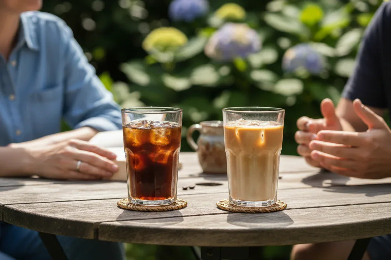 close-up-shot-of-a-garden-table-on-a-warm-summers-day-on-each-side-you-can-see-a-partial-image-of-2-people-sat-at-the-table-enjoying-a-chat-whilst-on-the-table-the-focus-of-the-photo - Ignite Coffee Co